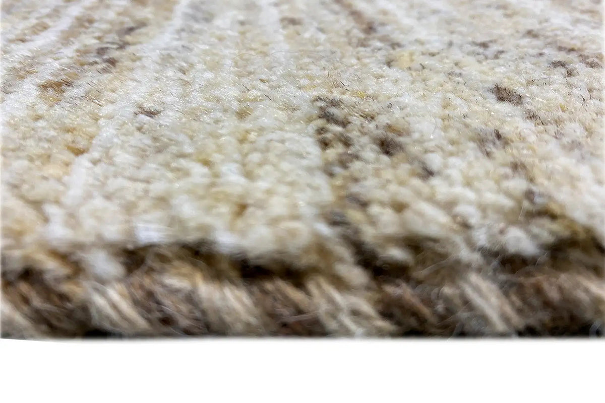 Gabbeh rug close-up: light pile with brown and gray gradients along the edge
