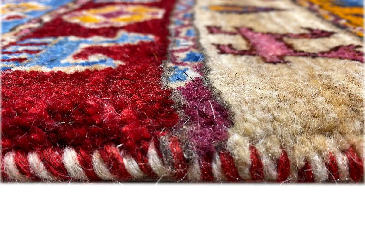 Gabbeh Lori rug detail: red and beige pile with white fringes