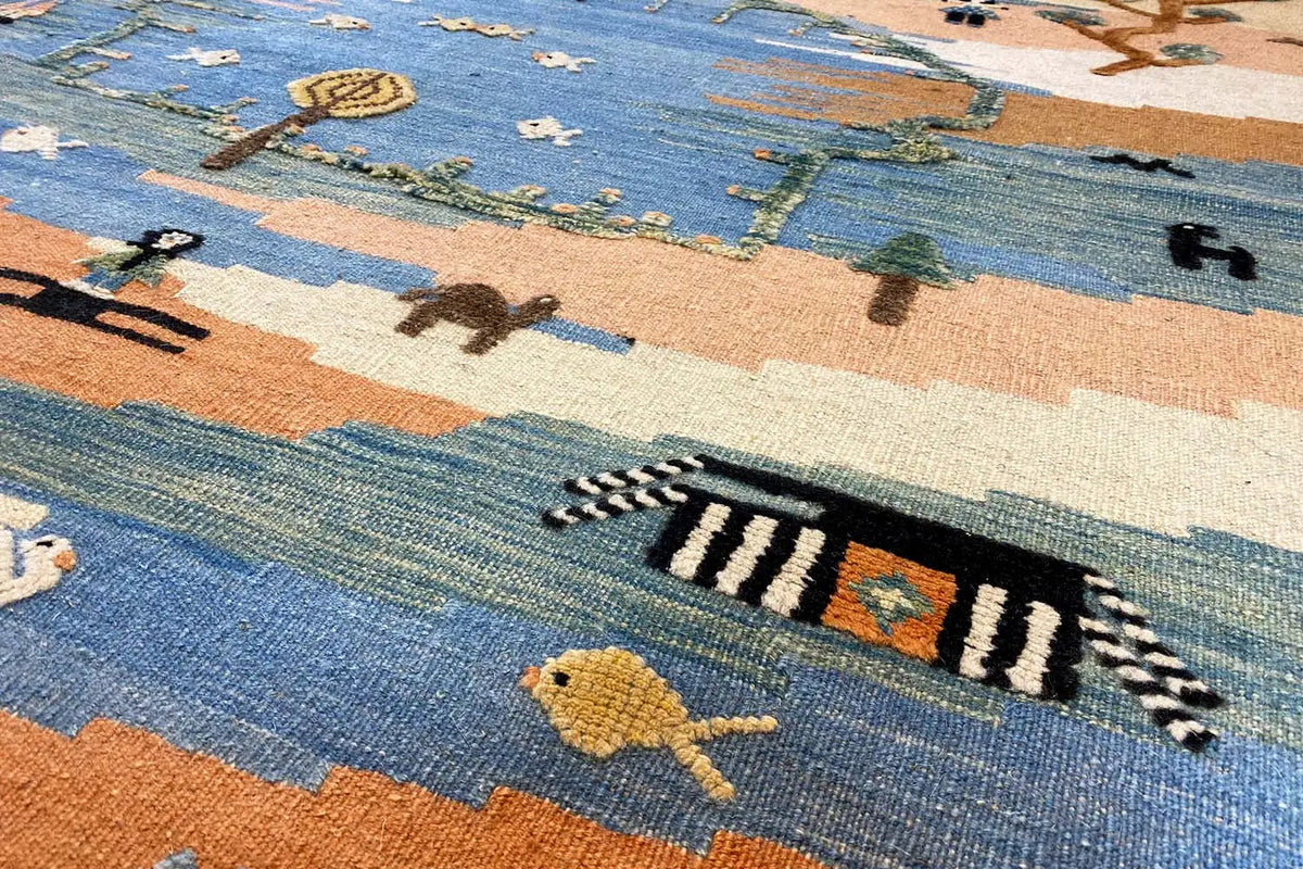Kilim Qashqai rug: Colorful pattern with animals and stripes in blue and beige