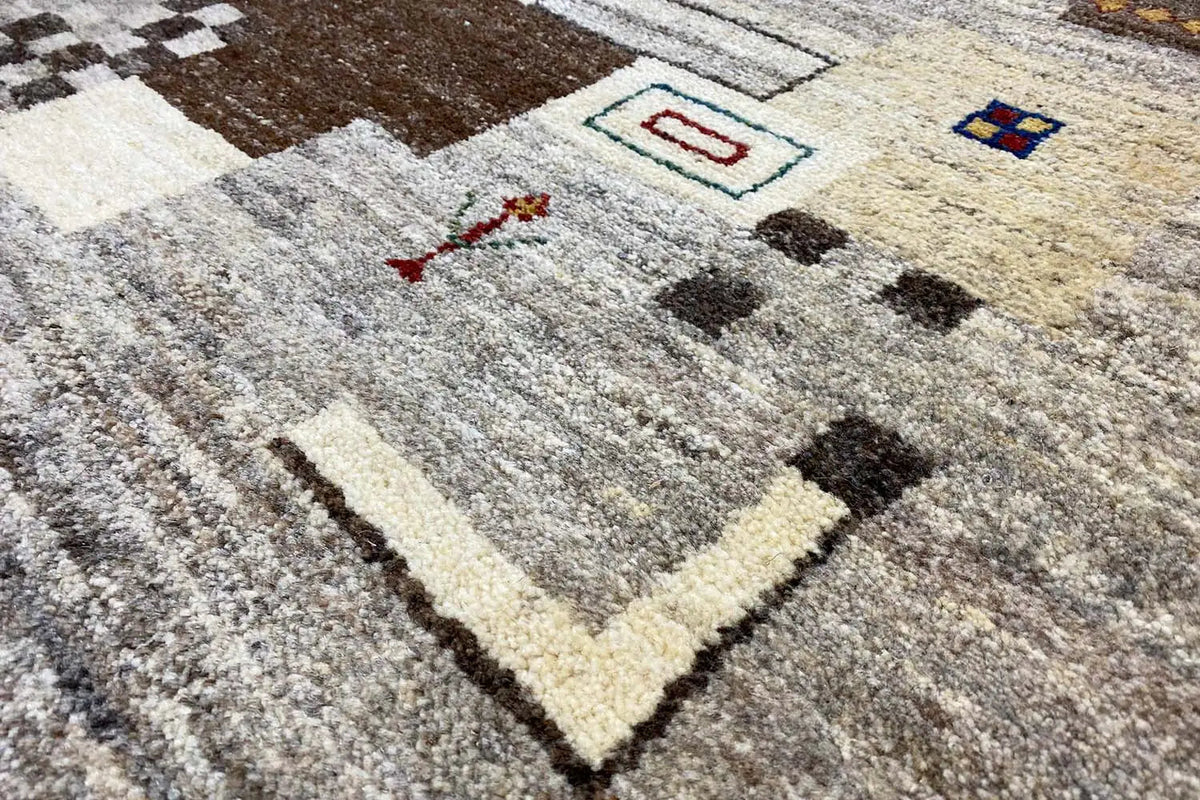 Gabbeh rug: geometric pattern in gray and cream with dark accents