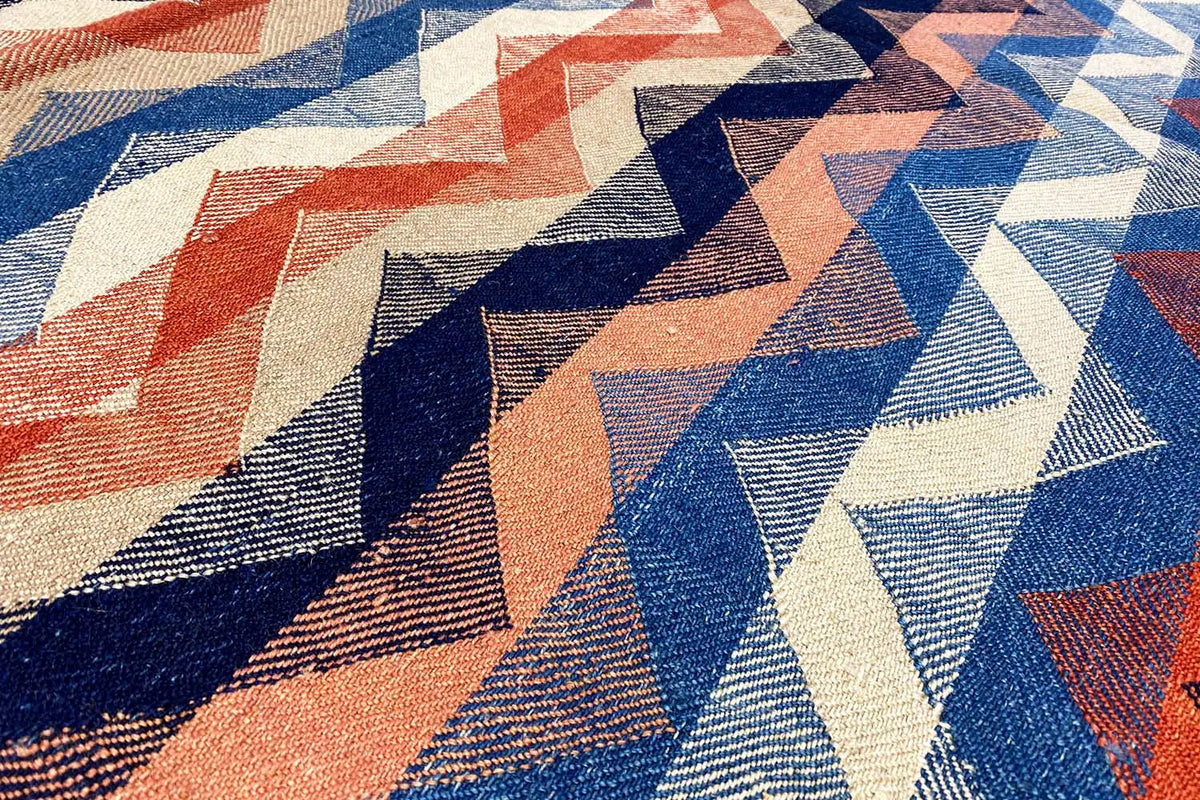 Carpet with a zigzag and block pattern in blue, orange, and cream