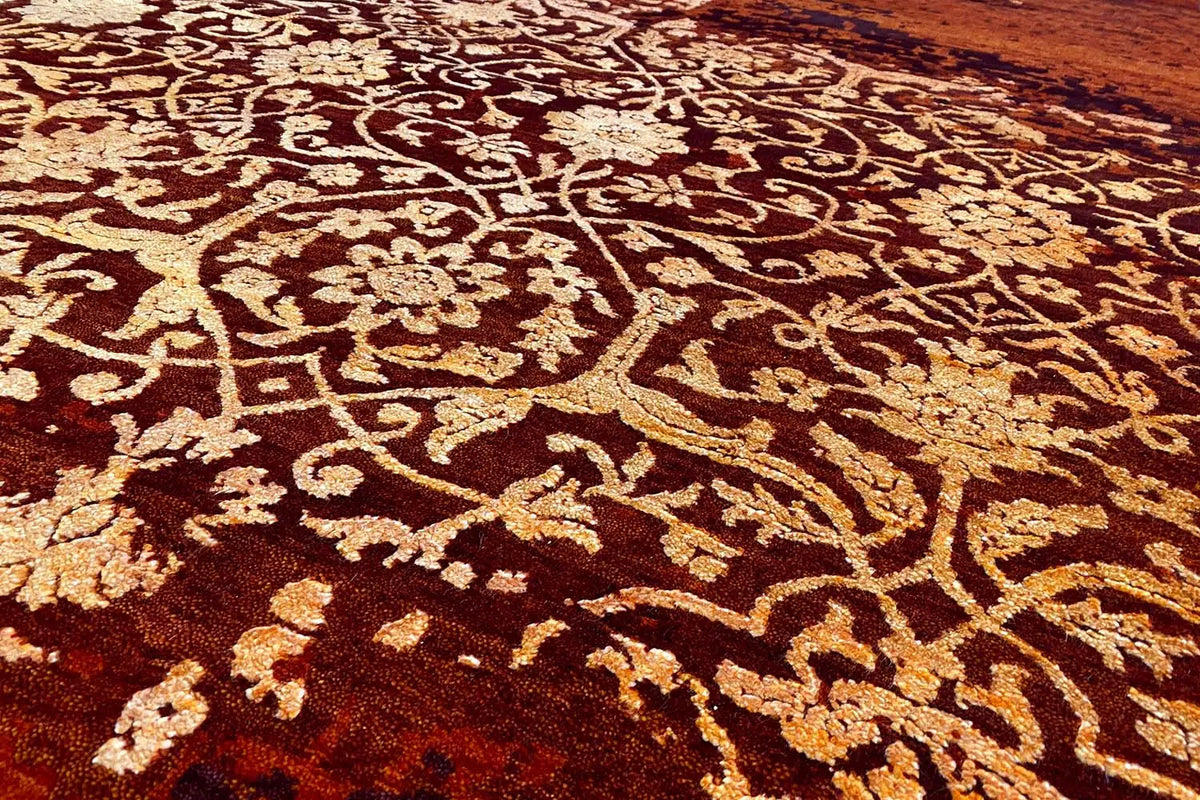 Carpet detail: reddish brown with gold-colored ornamental swirls