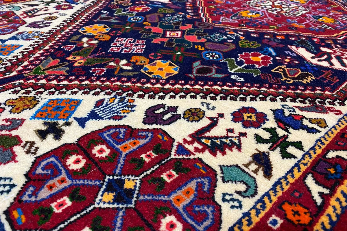 Detail of the carpet pattern with a blue background, colorful geometric motifs and ornaments