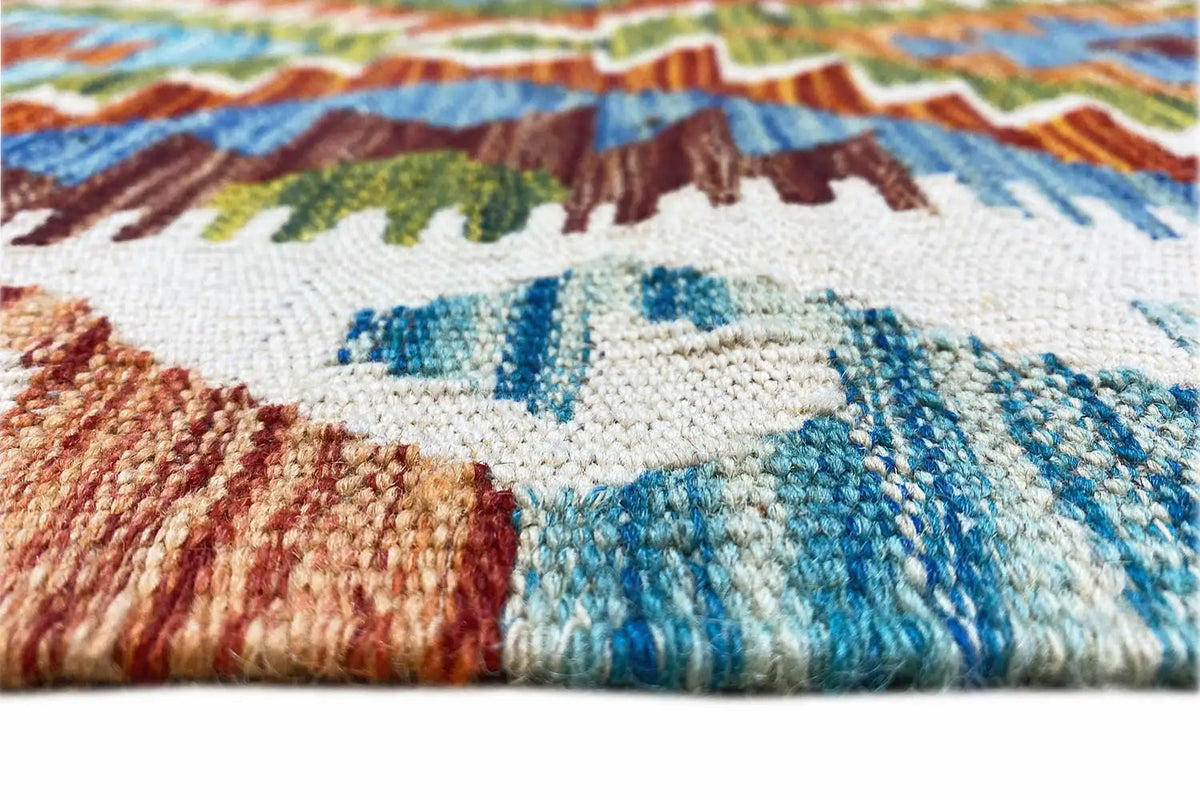 Kilim rug detail of the edge with a blue motif and fringes