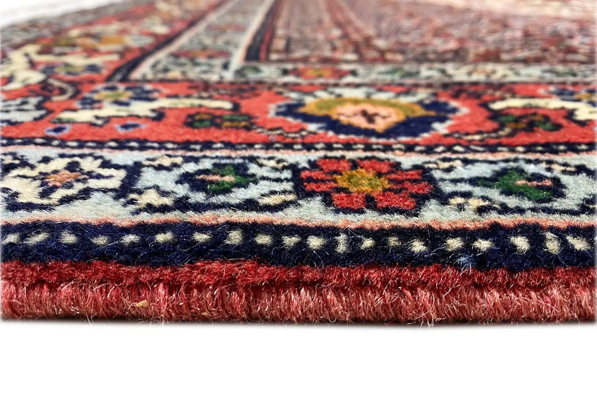 Hamadan carpet piece with a red fringed border and multicolored decorative pattern