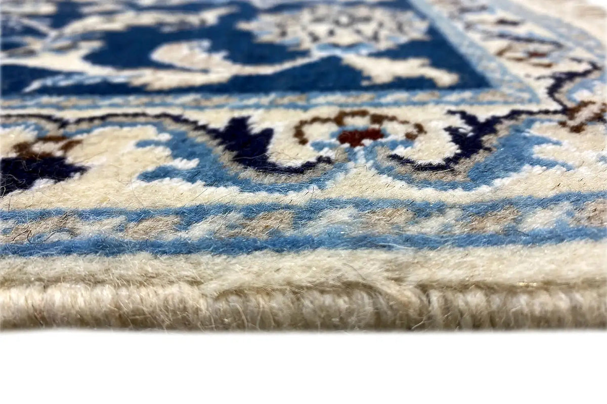 Carpet detail: blue and white pile with a fringed edge