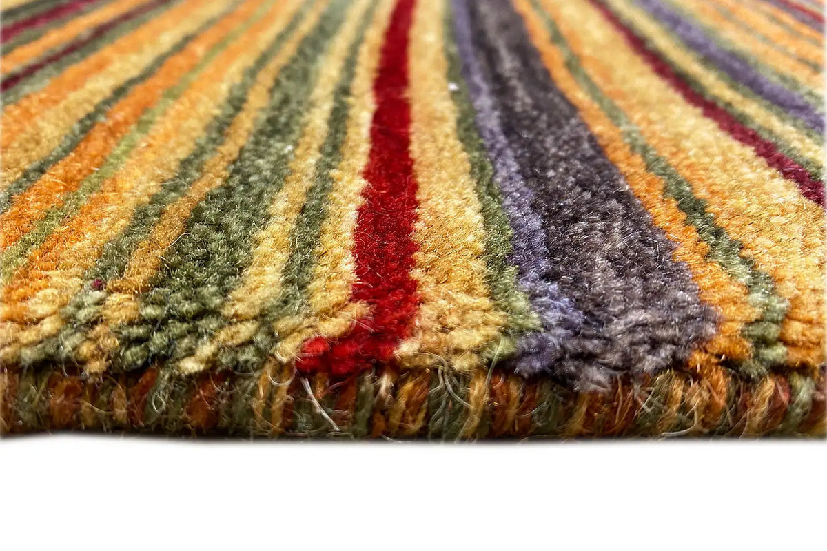 Gabbeh rug: multicolored stripes with a ruffled edge and visible pile texture