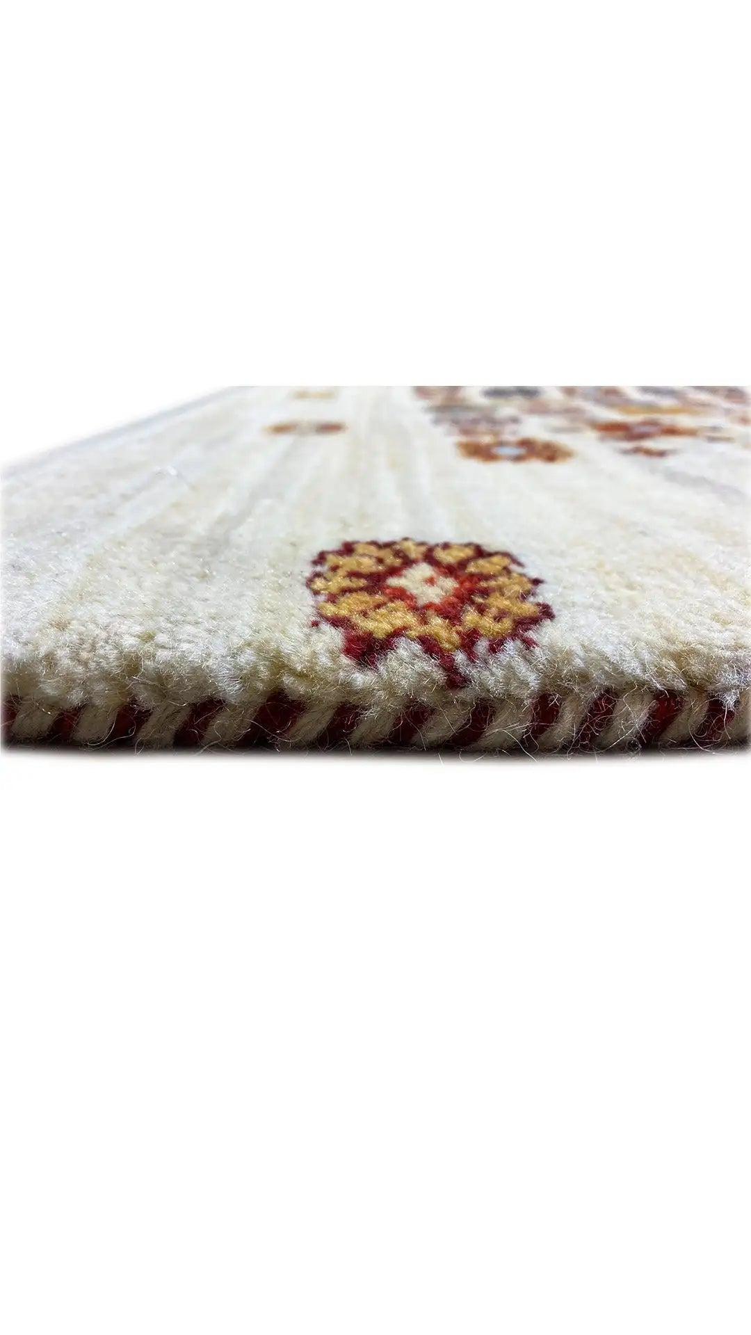 Carpet edge with short fringes and a multicolored pattern on a cream-colored background