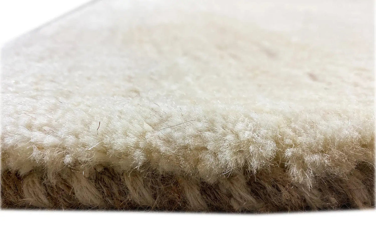 Gabbeh rug: side edge and pile, light beige, close-up