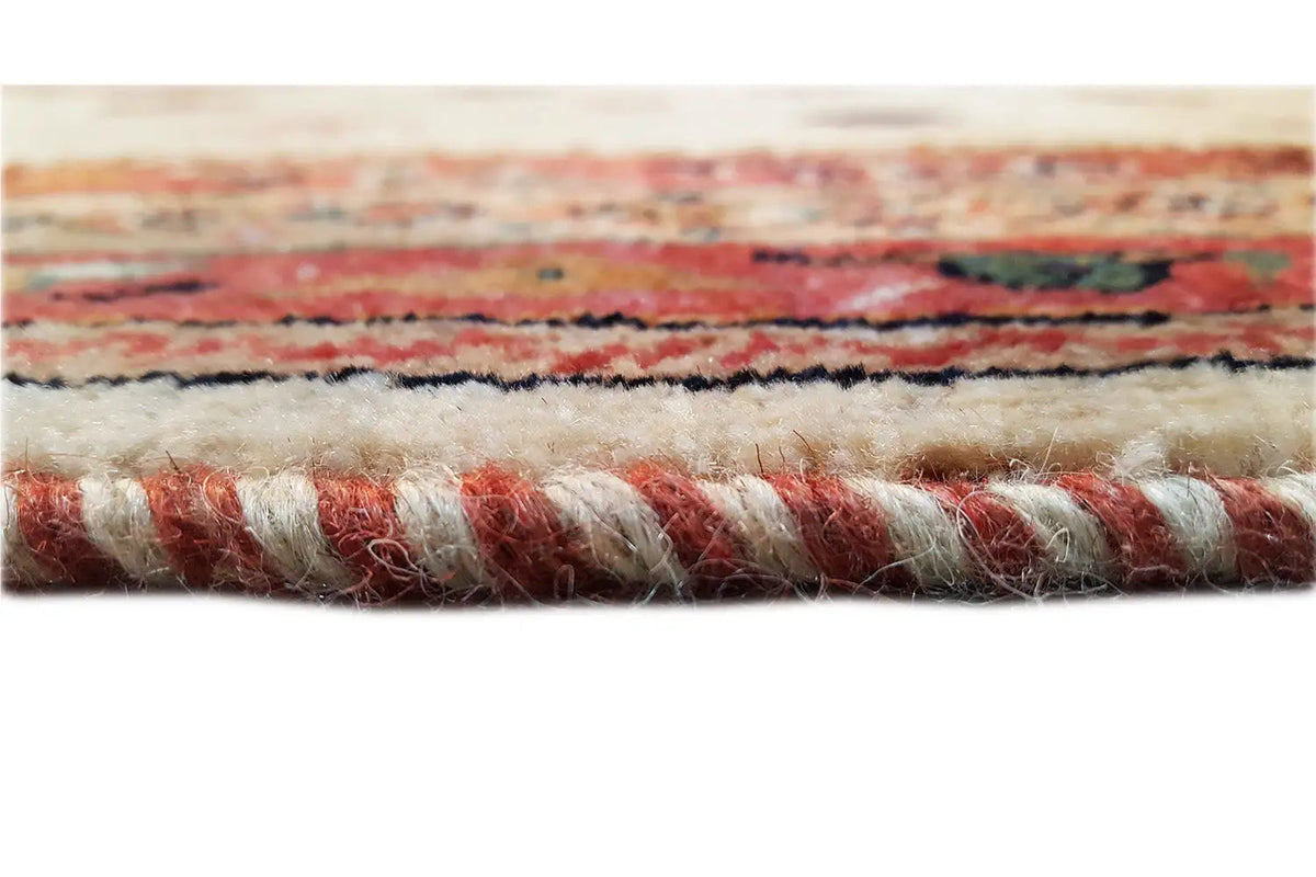 Carpet edge with a reddish-brown pattern and visible dense pile