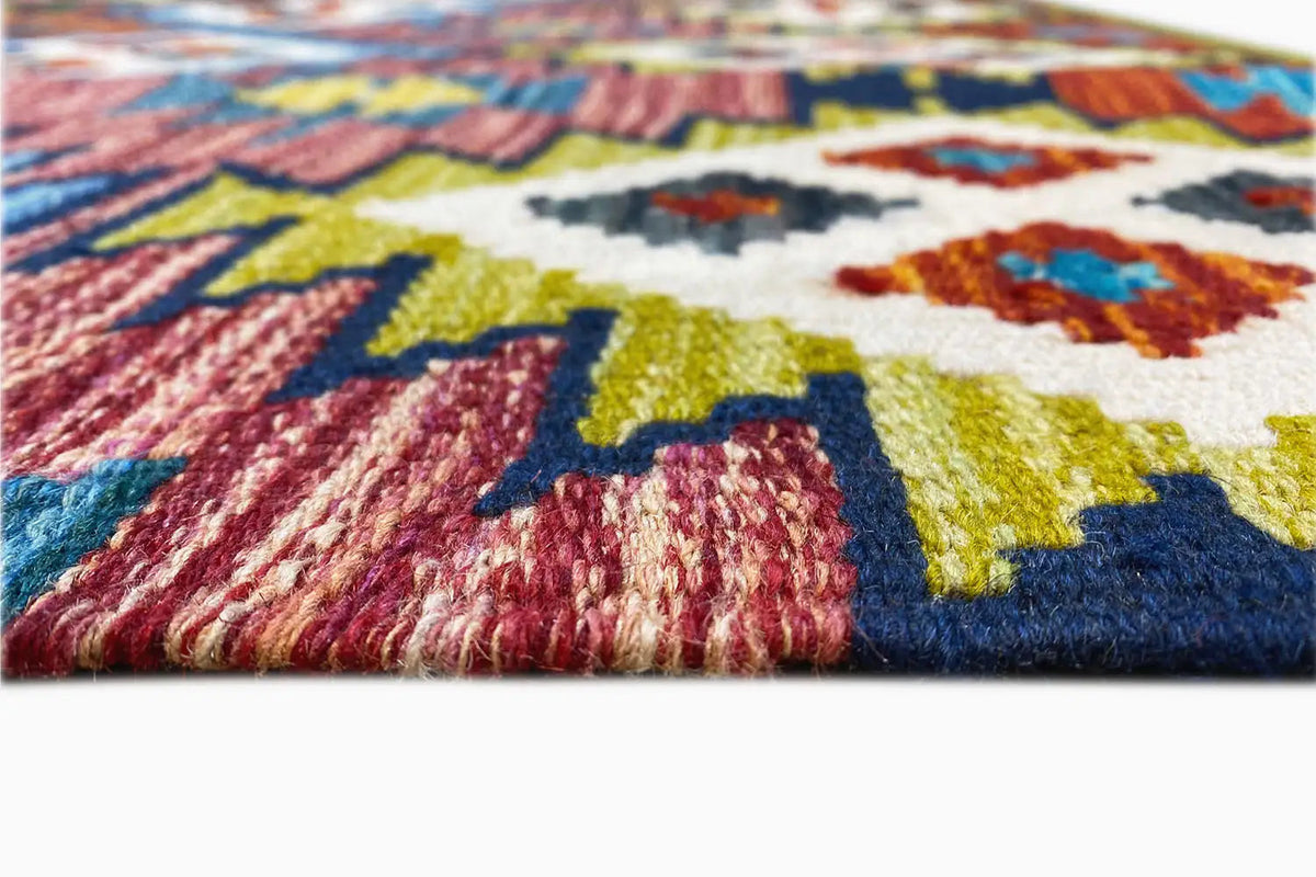 Kilim Afghan rug close-up: colorful woven texture and fringes along the edge