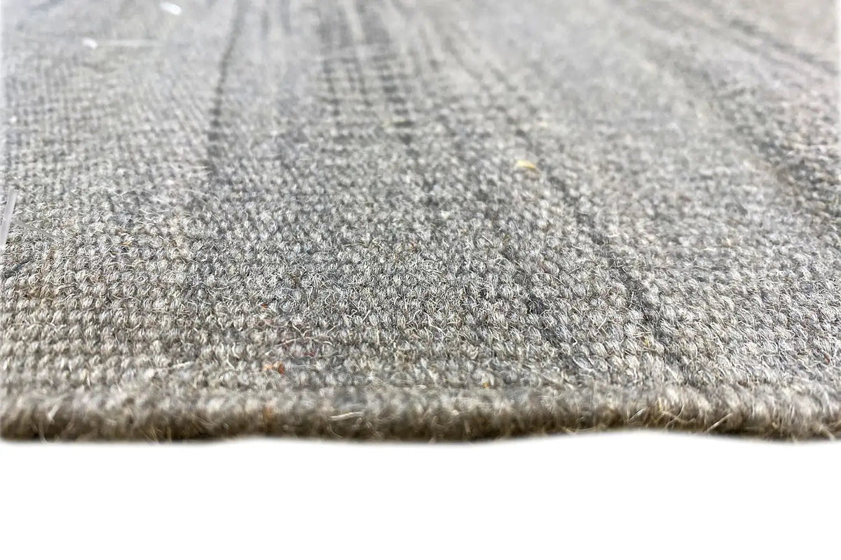 Close-up: gray kilim dhurrie rug, woven texture and short fringes