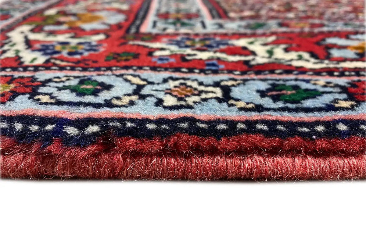 Hamadan carpet detail of the selvedge with red pile and multicolored border edging