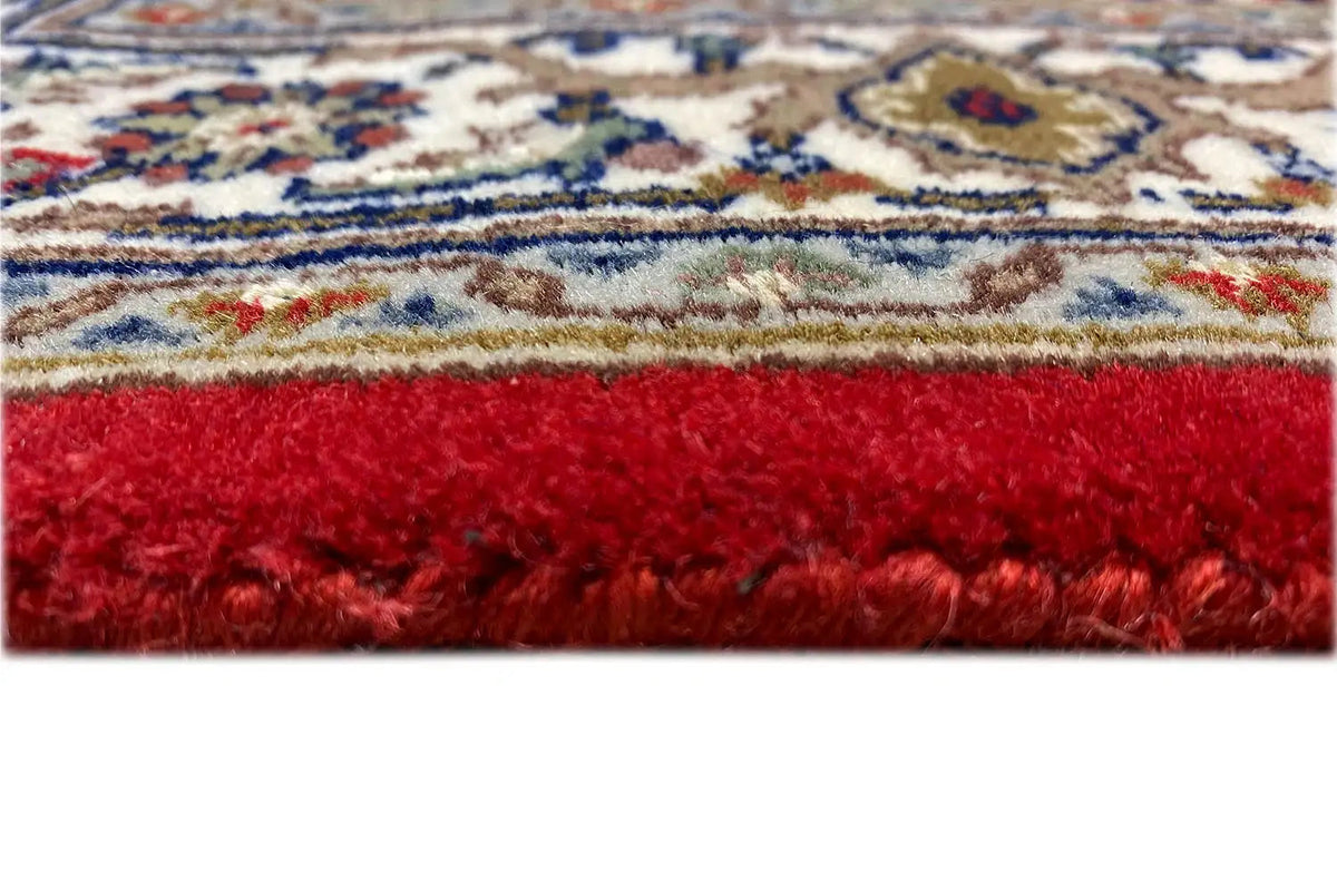 Bidjar runner detail: dense burgundy pile with a bordered finish.
