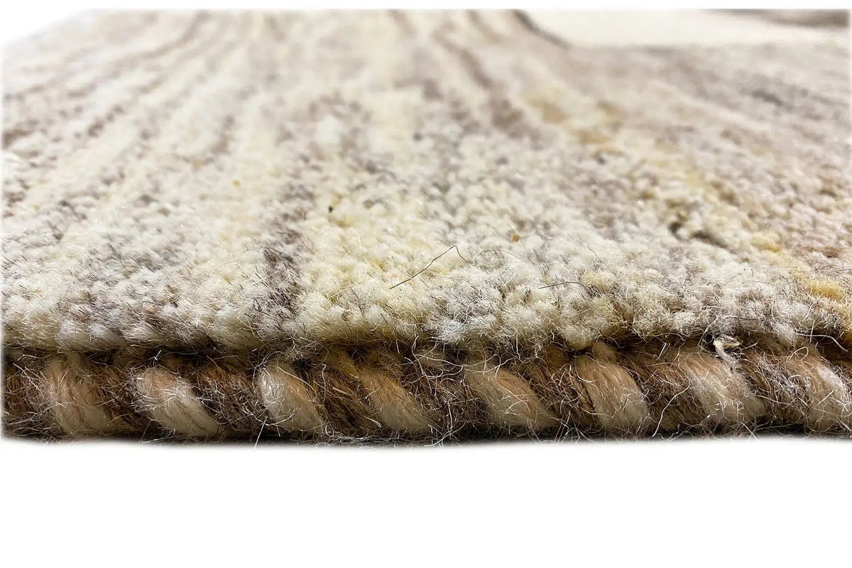 Close-up of the carpet pile: soft, short fibers with darker and beige tones