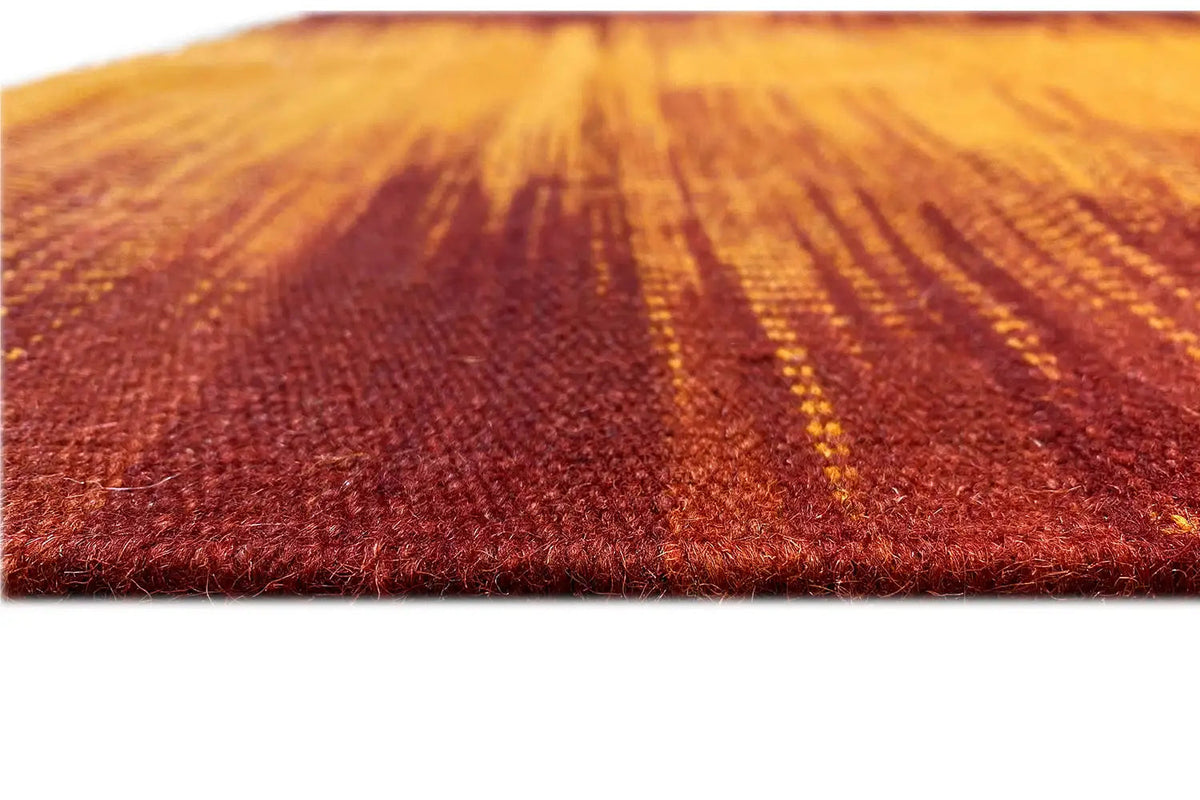 Kilim rug close-up: orange-yellow and reddish stripes, low pile