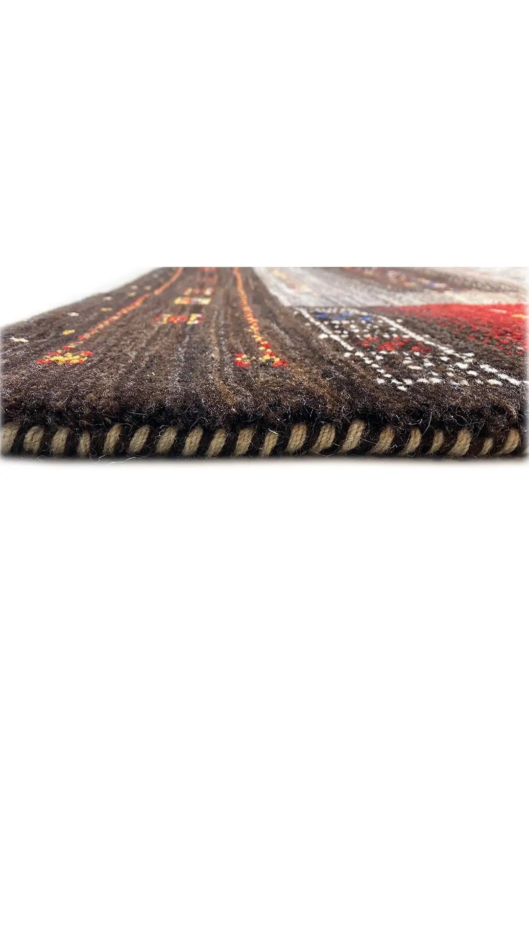 Rug edge with a multicolored pattern and black fringed finish