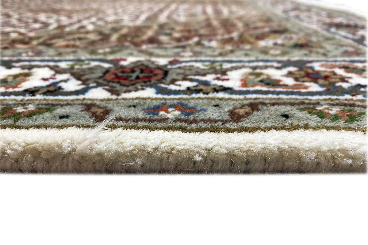 Tabriz carpet detail: pile surface and fringe, close-up of the carpet edge