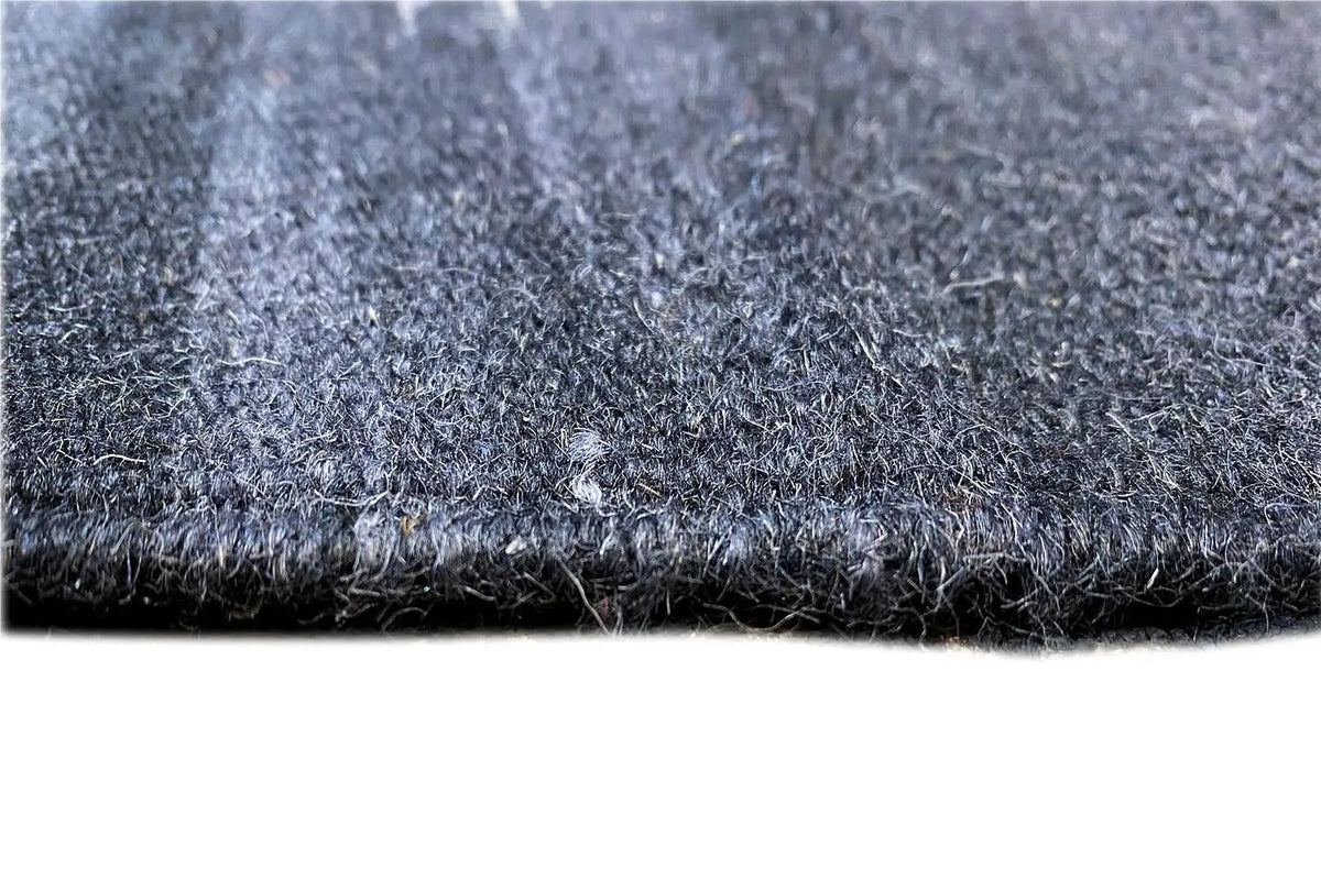 Close-up: blue-gray carpet pile with a short, dense surface