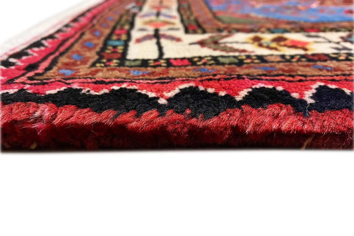 Hamadan rug detail showing the border with fringe and dense red pile