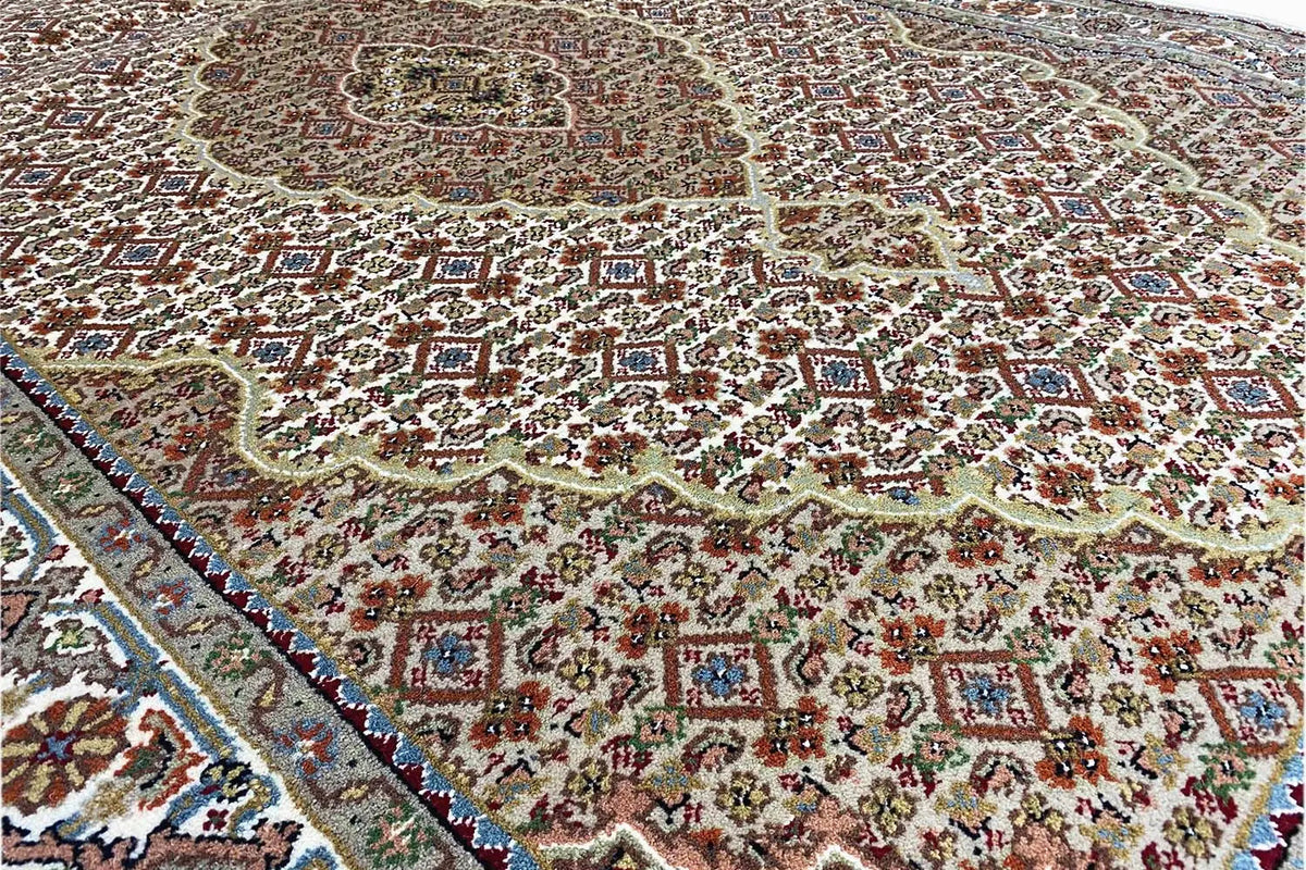 Carpet detail with a dense ornamental pattern and blue decorative border