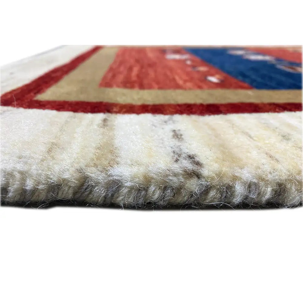 Carpet edge with dense cream wool pile; red/blue pattern underneath