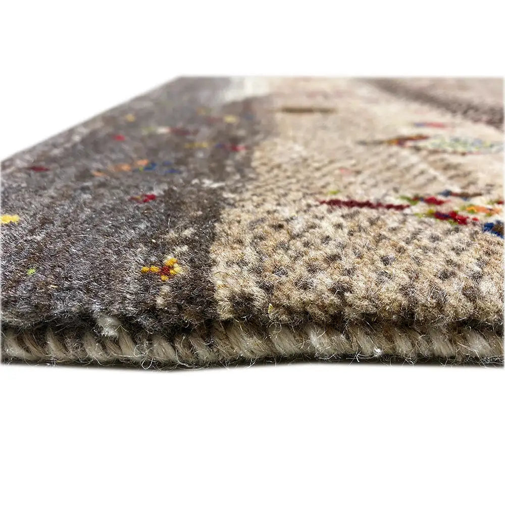 Gabbeh rug close-up of the edge: dense pile, beige and dark gray with colorful dots