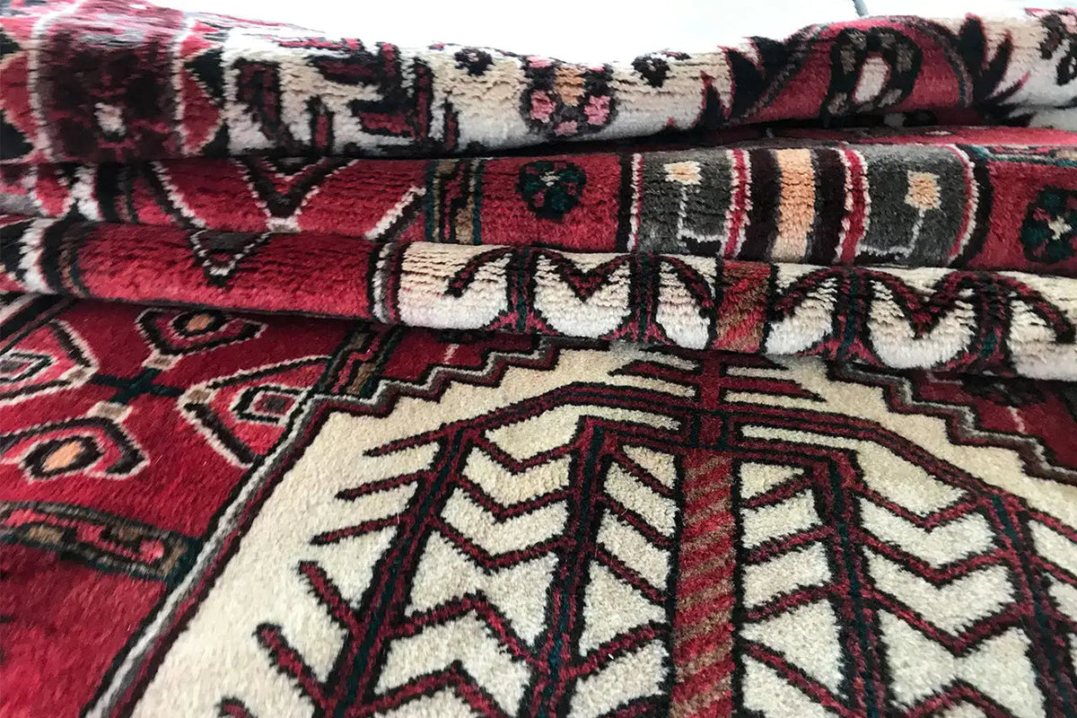 Hamadan runner detail view: red background with white, black, and gray linear ornaments