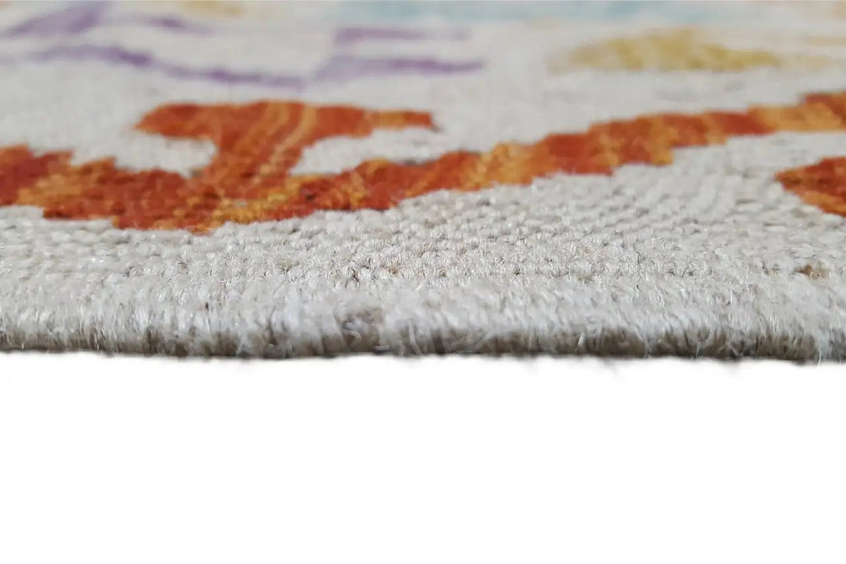 Kilim rug edge with fringe and a dense woven border, multicolored thread edging.