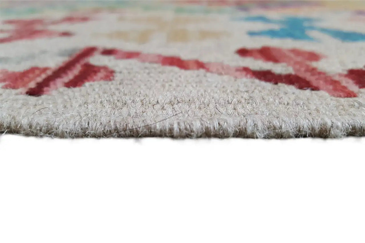 Kilim rug with short fringes along the bottom edge, multicolored pattern visible