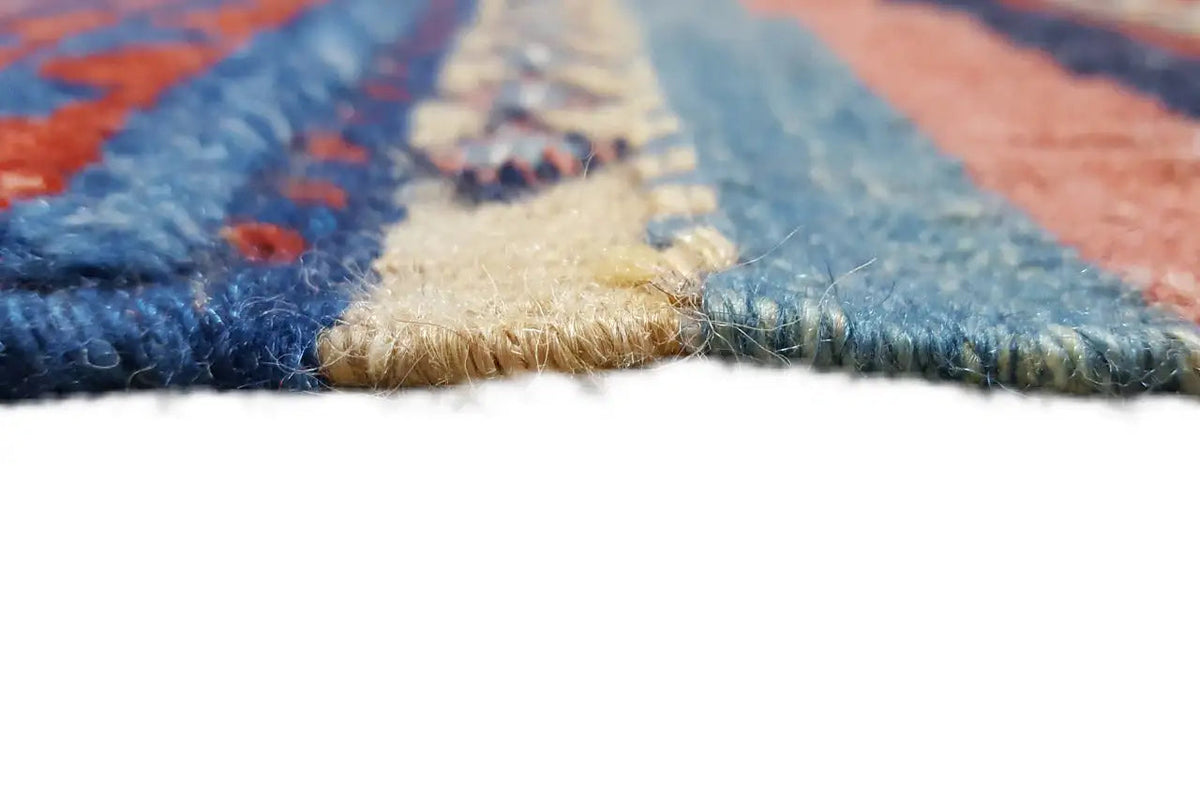 Bakhtiari kilim close-up, handwoven pile texture and fringes along the edge, blue and red
