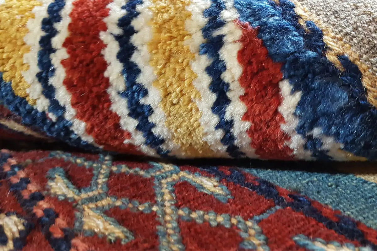 Close-up: Kilim fabric with blue, red, and beige stripes, visible texture
