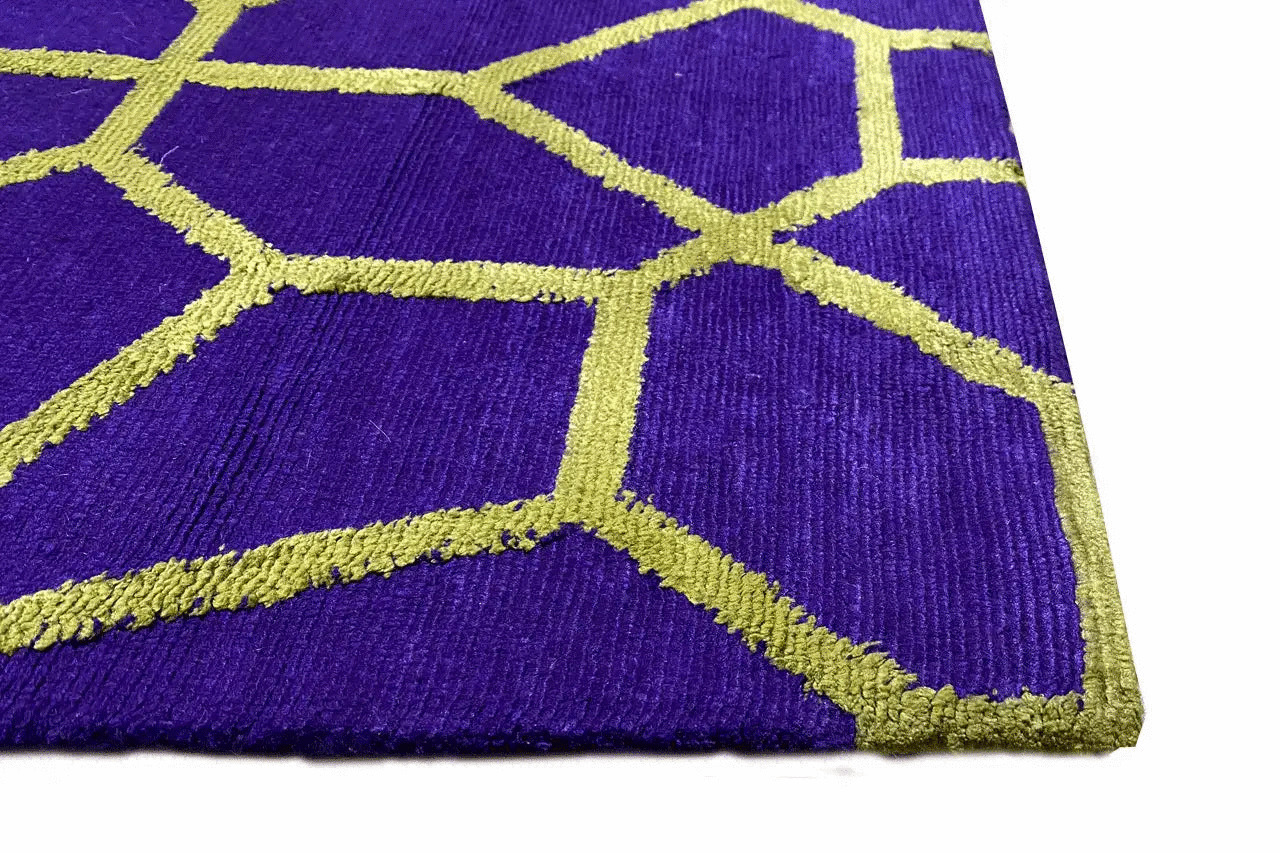 Carpet detail: purple pile with golden yellow-green decorative lines in a geometric pattern