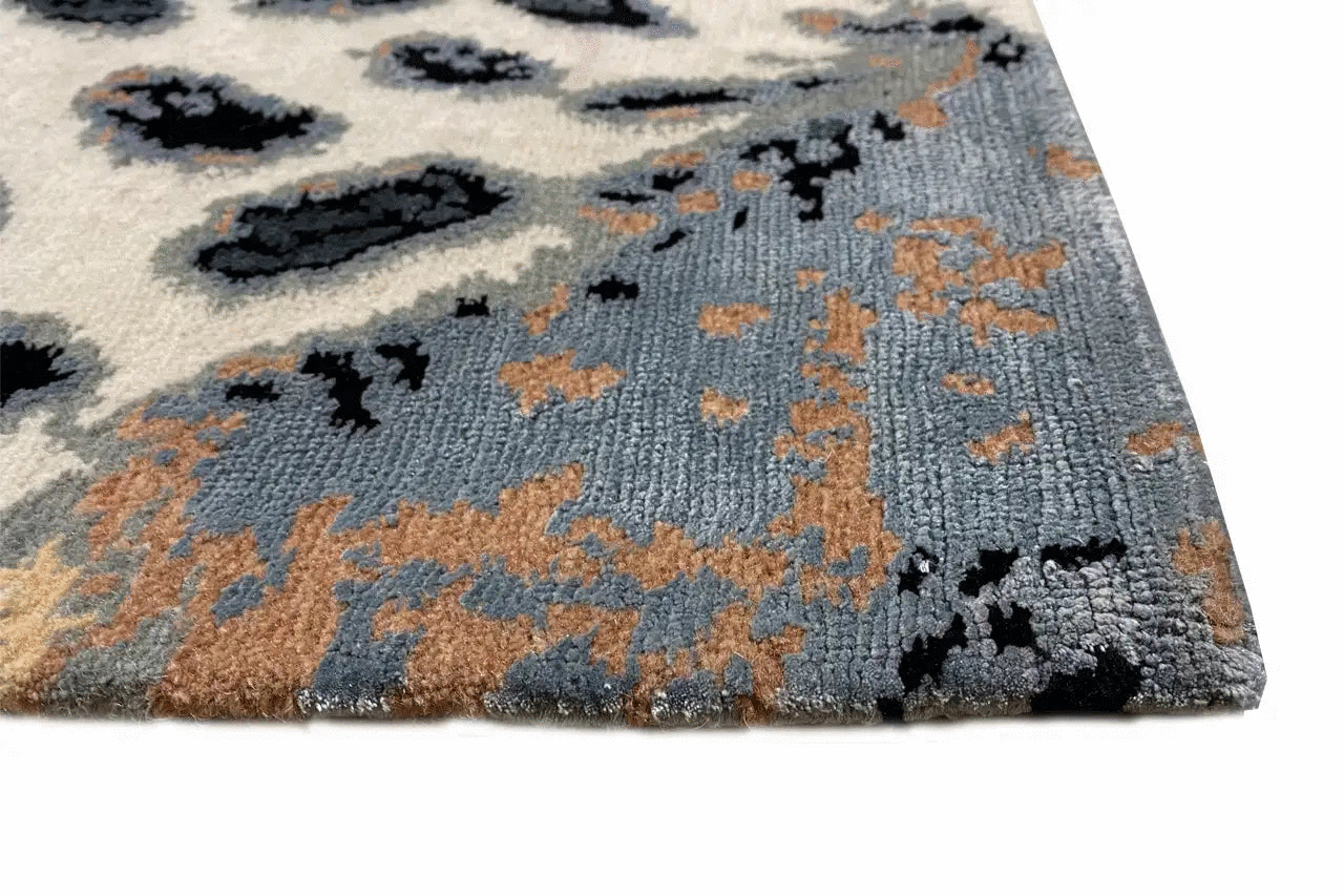 Designer rug: close-up, blue-gray pile with brown color patches and clouds