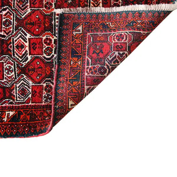 Close-up of the carpet edge: red ornamental field with a dark border