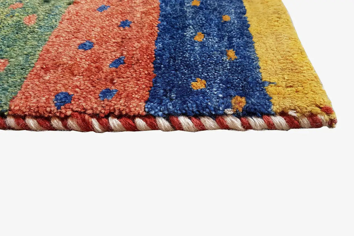 Gabbeh rug close-up of the selvedge with multicolored stripes and dots
