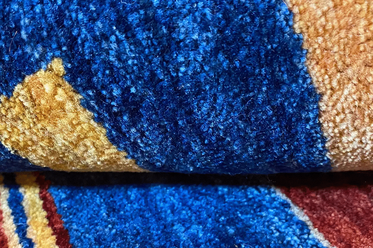 Gabbeh rug detail: blue and beige pile stripes, dense wool weave