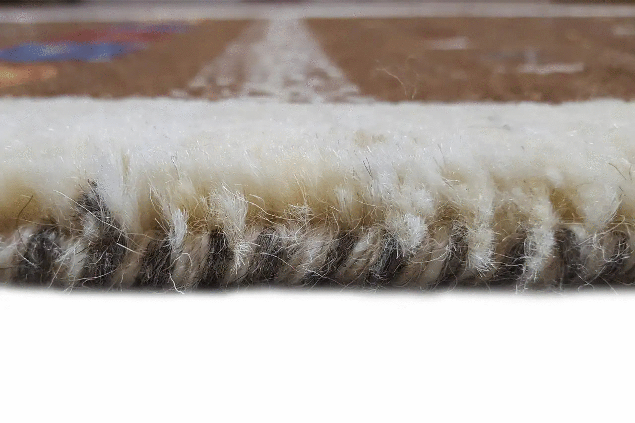 Gabbeh rug, side view of the pile: dense brown wool felt with a light-colored edge