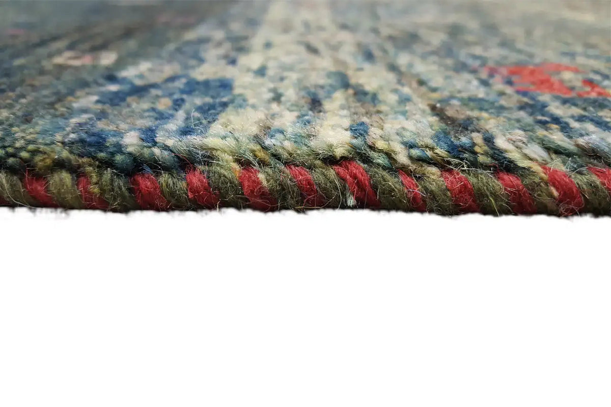 Gabbeh rug end fringe: dark green border with red and green threads.