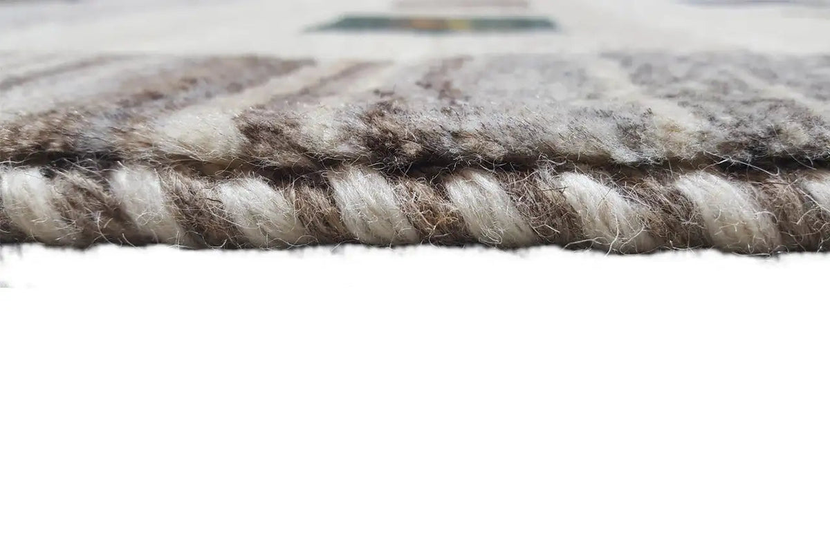 Gabbeh rug edge in detail: twisted fringes, multicolored woven texture