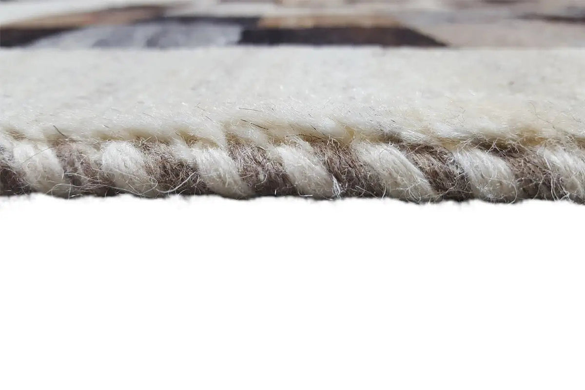 Gabbeh rug close-up of the edge with fringe, beige pile