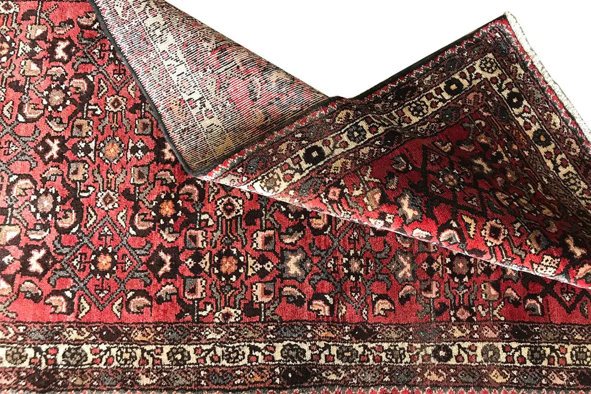 Oriental rug runner, red and black, with ornaments and a wide border along the edge