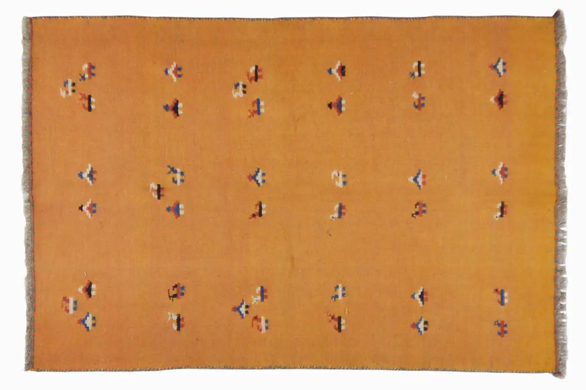 Rectangular ochre-brown kilim rug with delicate multicolored patterns and a fringed edge