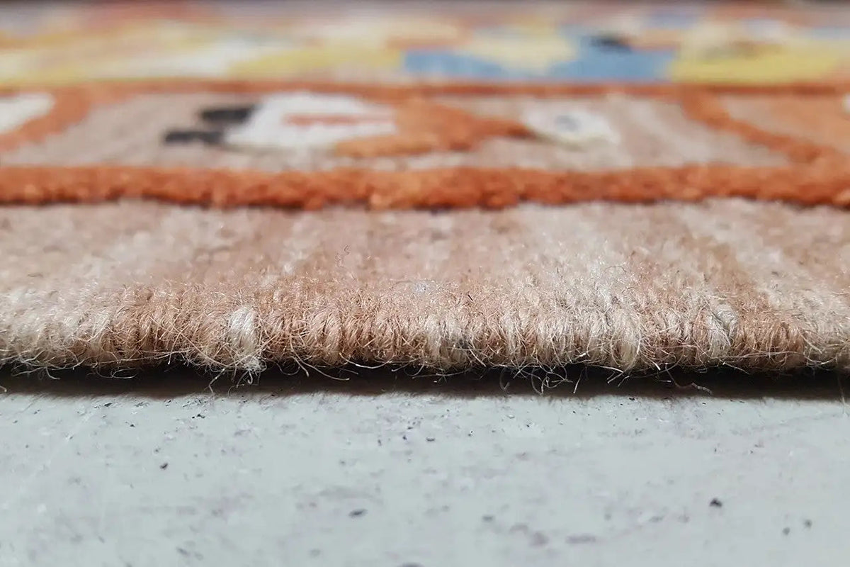 Close-up of a Qashqai kilim rug: pile with fringed edge along the bottom edge