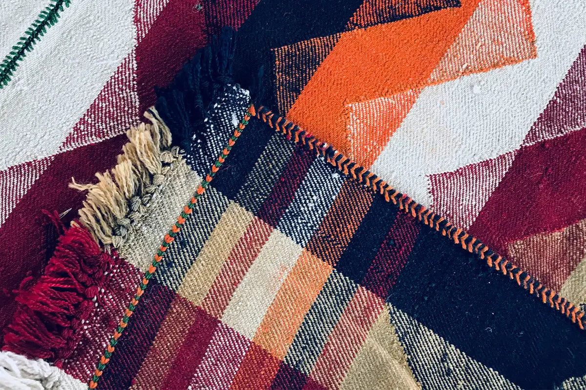 Close-up of a Jajim rug: zigzags and checks, with fringes and a coarse weave clearly visible