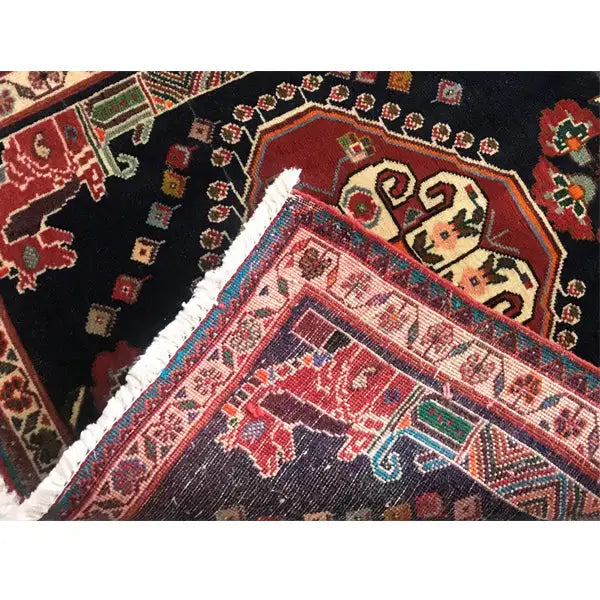Detailed view: colorful Oriental rug with a red medallion and light border ornaments