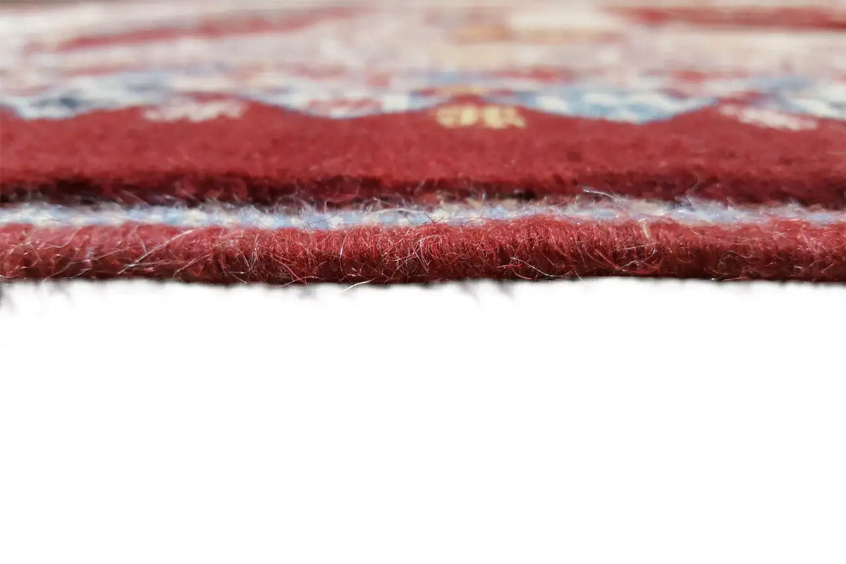 Rug edge with a fine pile and multicolored stitching, reddish-brown border