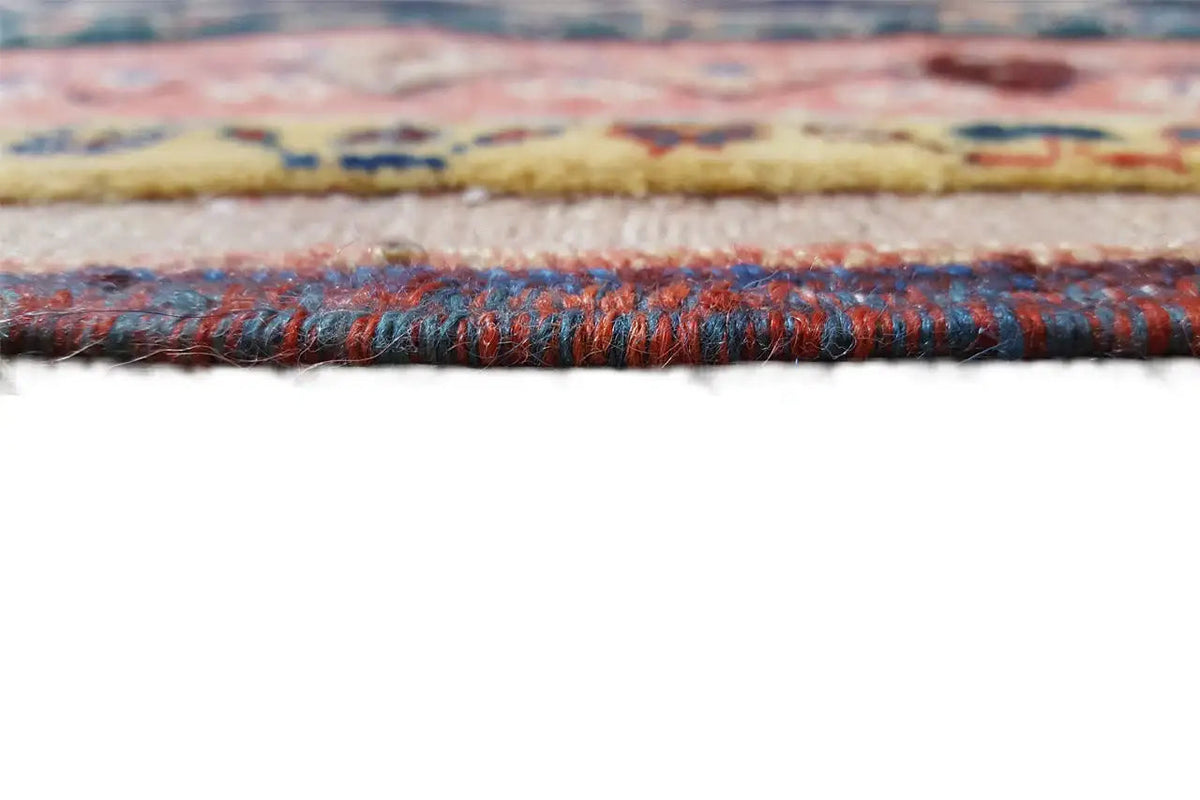 Rug edge with a multicolored pattern and thick fringe trim