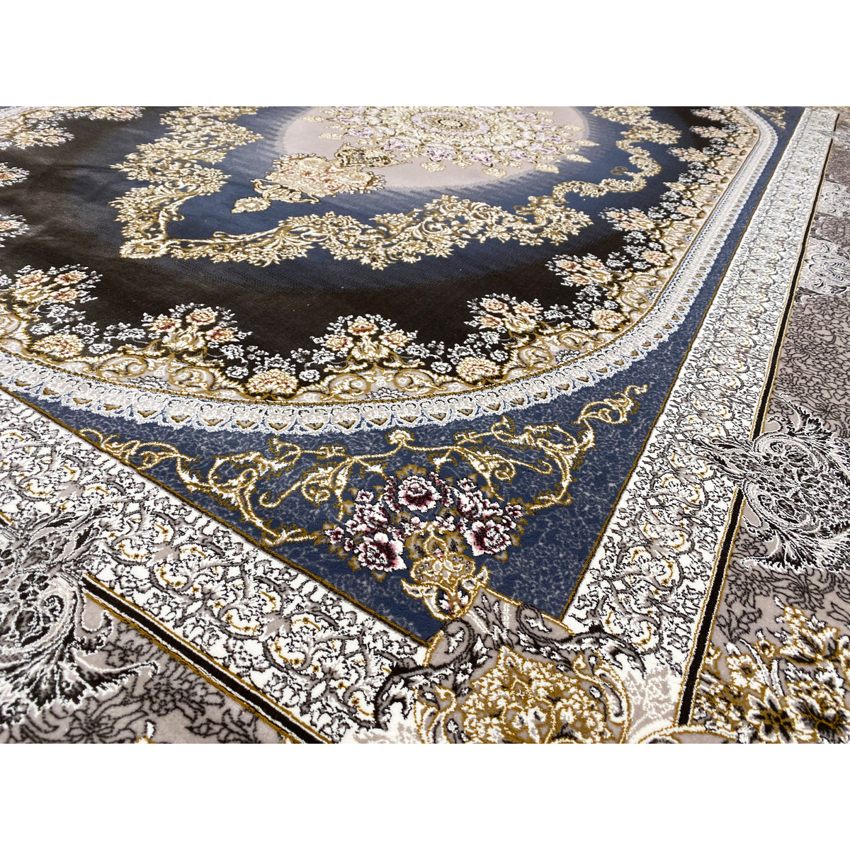 Close-up of a rug with a floral pattern, gold accents, and a silver border around the edge.