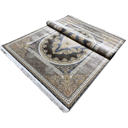 Rolled-up carpet: dark blue central area with a gold-and-silver ornamental pattern and border.